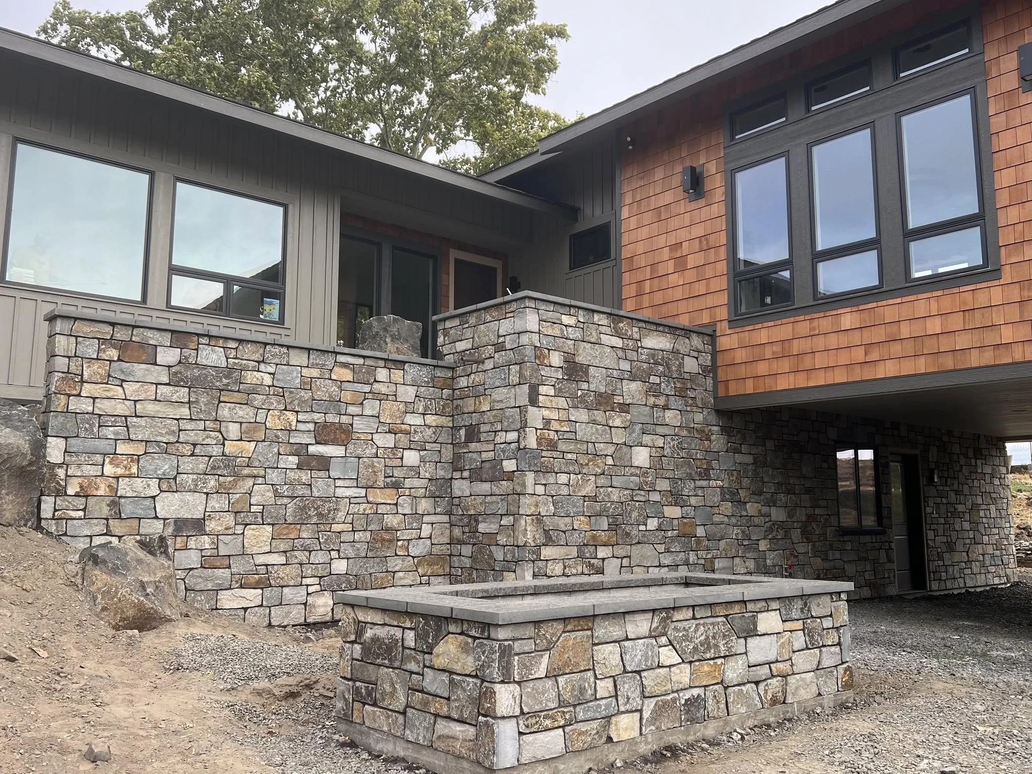Contemporary home with stone walls and cedar siding, an Alano Masonry project